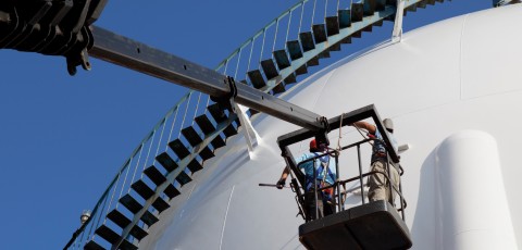 An image showing a work man carrying out commercial decorating services on a building