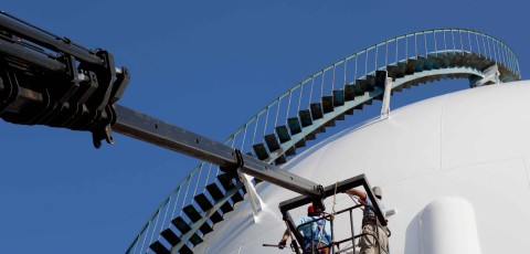 Industrial painters on a crane