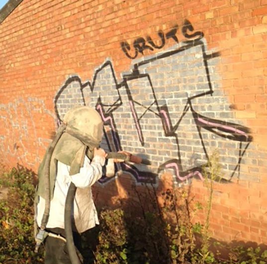 An image of Tyseley Industrial Park using shot blasting techniques to remove graffiti