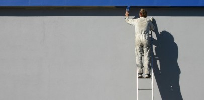 an image of a man painting a wall