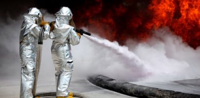 An image that shows two people extinguishing a fire.